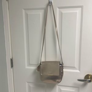 New crossbody purse. Rose Gold.  No pockets on inside or outside.